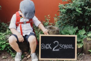 Boy with back to school sign