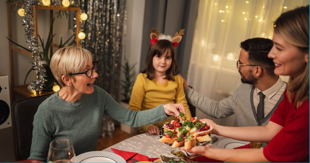 Family during the holidays enjoying a meal while using better communication from Jody Sargent, LCSW's tips.